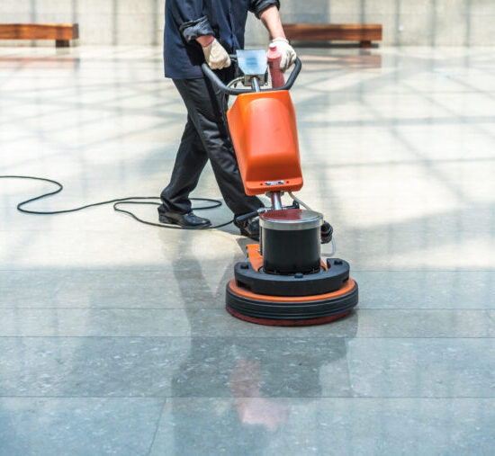 Man buffing floor of commercial building - Conyers commercial cleaning floor care
