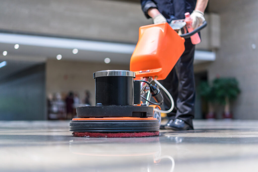 Commercial cleaning close up of man buffing tile floor